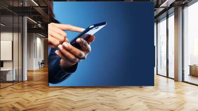 Extreme close-up of the hands of a woman using a smartphone, the girl clicks the screen, on a blue background with copy space. Social media, text message and website, concept. Generative Ai. Wall mural