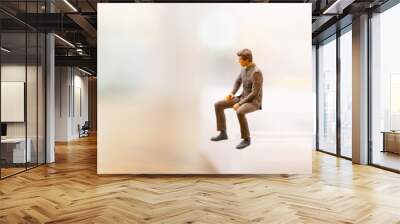 Miniature people : Businessman sitting on empty space Wall mural