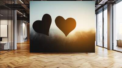 two felt hearts stuck in a window with condensation at sunset. Love and valentines day concept. Wall mural