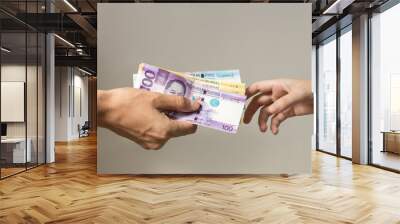 Hand holding giving cash banknotes Philippines peso paying bills, payment procedure or bribe, salary Wall mural