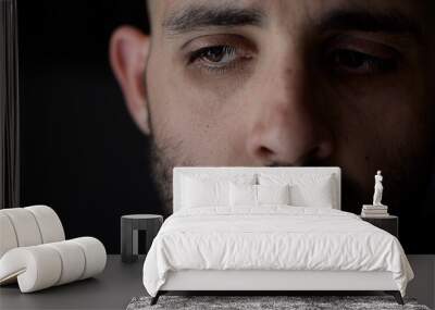 Portrait of worried man. Caucasian man in low key light, shallow depth of field Wall mural