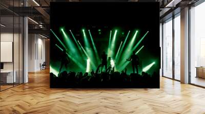 Silhouette of rock band at concert. People crowd in concert green lights Wall mural