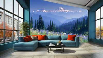 A panoramic view of the skyline from low to high, mountains in front and forested hillsides on side, covered with grasses and wildflowers. The sky is clear blue, scene embodies pure nature Wall mural