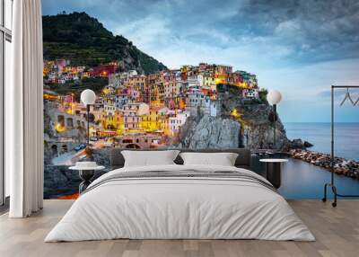 Manarola Village, Cinque Terre Coast of Italy. Manarola a beautiful small town in the province of La Spezia, Liguria, north of Italy and one of the five Cinque terre travel attractions, Sunset colors Wall mural