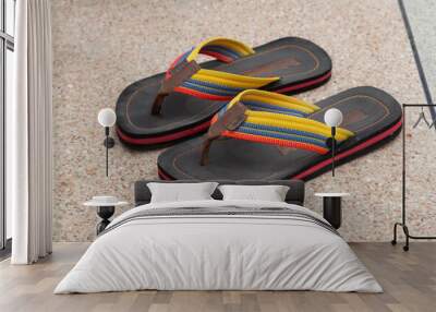 closeup of pair of fabric and rubber sandals with various colors, on the floor, casual style Wall mural