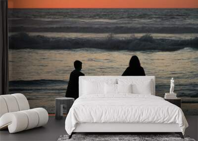 Brothers in a beautiful sunset on the beach Wall mural