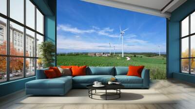 Wind turbines in beautiful sunny summer landscapes with clouds. Ecological energy generation. Ecological field of wind farm. Wall mural