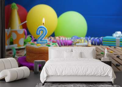 birthday cake with candles on rustic wooden table with background of colorful balloons, gifts, plast Wall mural