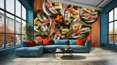 Top view of dishes with fish Maitos, typical food of the Ecuadorian Amazon, accompanied with cassava, cooked banana and salad Wall mural