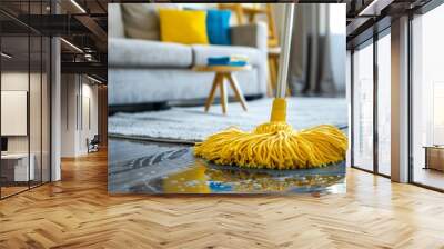 A yellow mop is placed on a damp wooden floor in a rectangular living room Wall mural