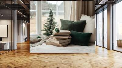 Cozy sofa with green pillow and books by Christmas tree. Wall mural