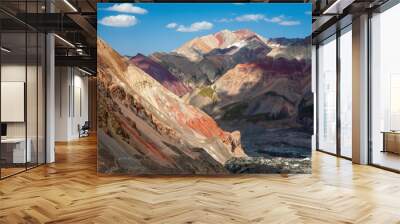 Beautiful landscape of mountain peaks. Hilly area. Mountainious terrain. Red sand. Wall mural