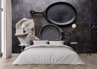 Two empty pan and linen napkin on stone background close up with copy space, flat lay Wall mural