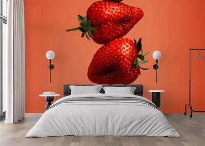 Fresh strawberries stacked on a gold fork against vibrant red background. Creative food concept. Minimal spring or summer fruit composition. Organic vegetarian diet. Tasty healthy vitamin snack. Wall mural