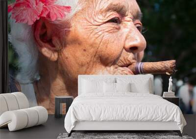 Old wrinkled woman smoking cigar Wall mural