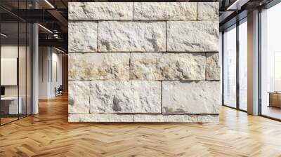 Textured limestone cladding stone wall made of rectangular blocks in light beige and cream colors, showcasing natural variations and imperfections. Wall mural