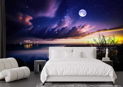   night at sea starry sky and moon on dramatic clouds sea water wave and stones on horizon blurred city light Wall mural