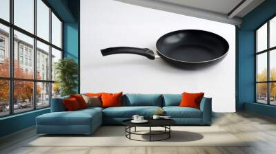 black fry pan over white background Wall mural