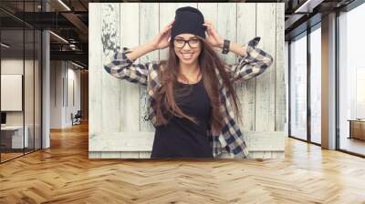 Hipster girl in glasses and black beanie Wall mural