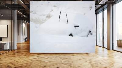 Car buried under a thick layer of snow after snow storm Wall mural