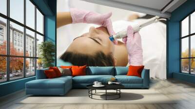 First-person view of cosmetologist doing beauty procedure at cosmetology clinic Wall mural