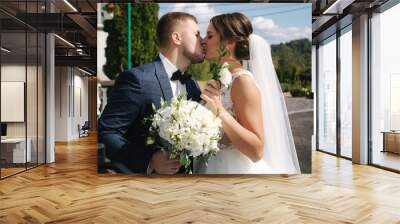 Firtst look of groom and bride by the church Wall mural