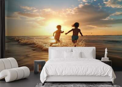 happy two children ,small boys on sunset sea run and play on beach and in sea water, sunbeam light refclection on wave splash drops   Wall mural