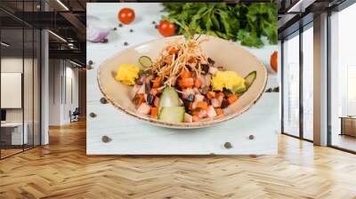 Fresh salad on brown plate on white textured table with cherry tomatoes and chilli and pepper spices and green at background Wall mural