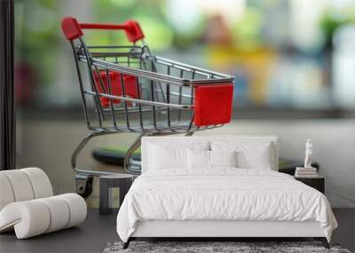 Mini Shopping Cart with Red Handle on Table with Smartphone, Online Shopping and E-commerce Concept. Wall mural