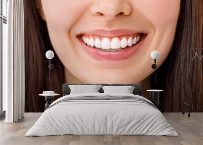 A beautiful woman is smiling. a smile with white teeth. Close up image. Wall mural