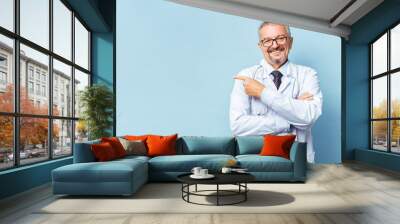 Cheerful mature doctor posing and smiling at camera, healthcare and medicine. Wall mural