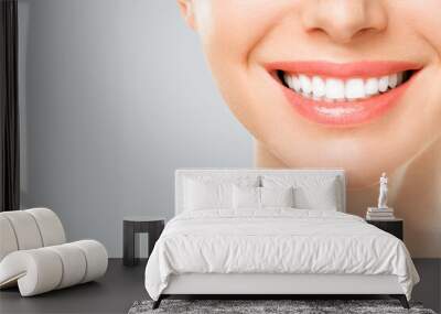 Perfect white teeth smile of a young woman. The result of the teeth whitening procedure. The image symbolizes oral care dentistry, Closeup on a white background. Wall mural