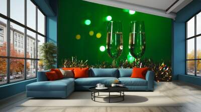 Toasting with champagne glasses against holiday lights and new year fireworks Wall mural