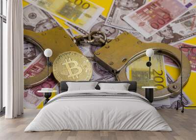 Bitcoin Cryptocurrency on banknotes. euro banknotes, dollar and police handcuffs. Wall mural