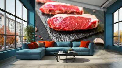 New york strip porterhouse steak meat with spices and herbs against black background Wall mural