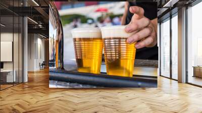 Serving cold beer at a street food market Wall mural