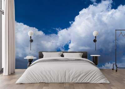 White cumulus clouds on a blue sky, background and texture. Wall mural