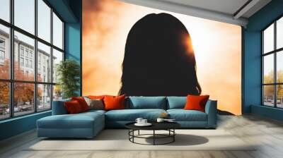 A dramatic image of Jesus Christs silhouette depicted against a backdrop of bright cascading light from the heavens The rays of light form a powerful and divine presence emphasizing the concept  Wall mural