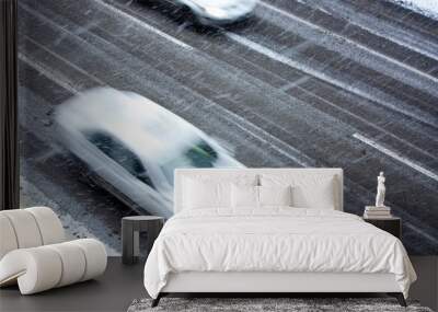 Driving cars on the snowy city street in motion blur Wall mural