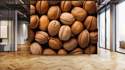 Background of unshelled walnuts. Close-up Wall mural