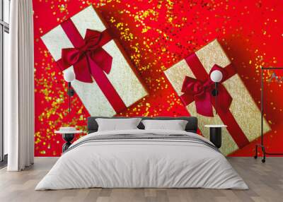 two gift box with bowes on red-gold background Wall mural