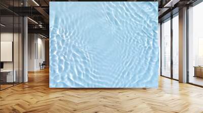 Blurred transparent blue colored clear calm water surface texture with splashes and bubbles. Trendy abstract nature background. Water waves in sunlight. Wall mural