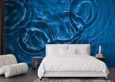 De-focused transparent dark blue colored clear calm water surface texture with splashes and bubbles. Trendy abstract nature background. Water waves in sunlight with copy space. Wall mural