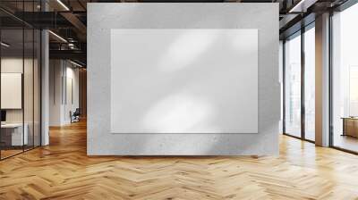 Empty white horizontal rectangle poster or business card mockup with diagonal dappled light spots on gray concrete wall. Flat lay, top view. For advertising, brand design, stationery presentation. Wall mural