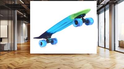 Pastel blue rainbow colored Penny board skateboard standing on two wheels isolated on white background. Plastic mini cruiser Youth minimalistic Sport inspired summer fun concept. Copy space. Wall mural