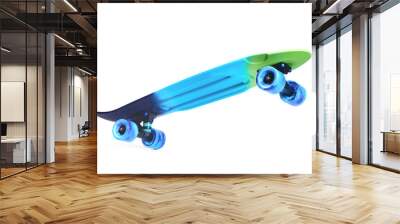 Pastel blue rainbow colored Penny board skateboard standing on two wheels isolated on white background. Plastic mini cruiser Youth minimalistic Sport inspired summer fun concept. Copy space. Wall mural