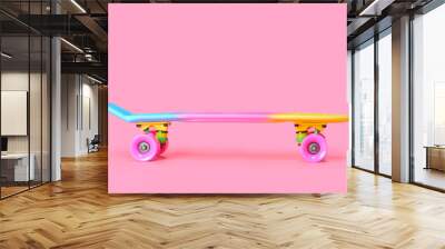 Pastel neon rainbow colored Penny board skateboard isolated on solid soft pink background. Plastic mini cruiser. Youth minimalistic Sport inspired summer fun concept. Copy space. Wall mural