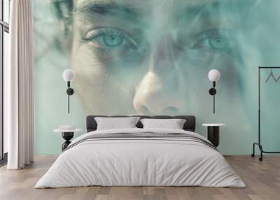 Minimalistic double exposure effect photography of a woman's portrait with green eyes, set in foggy soft light and muted pastel colors.
 Wall mural