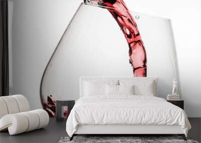 Red wine poured in a glass isolated on white background Wall mural