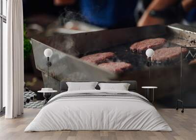 Chef making burger meat at the open air restaurant grill. Festival food, fast food restaurant Wall mural